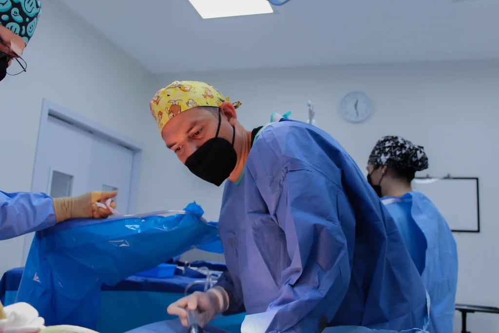 Plastic Surgery in Tijuana, Mexico 16 A board-certified plastic surgeon in Mexico performing a procedure in a modern operating room, ensuring safe cosmetic surgery abroad as part of affordable plastic surgery packages.