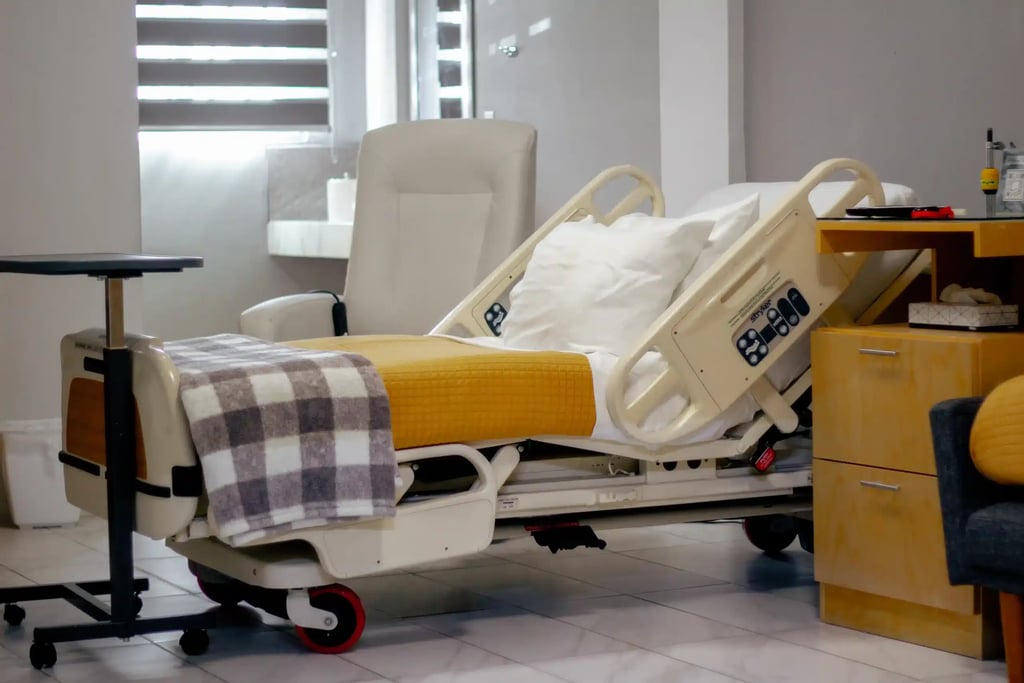 Transgender Surgery in Tijuana, Mexico — Align Your Body & Identity 20 Modern, comfortable hospital bed and high-end furniture in a private room in Tijuana, focused on post-operative recovery for transgender surgery patients.