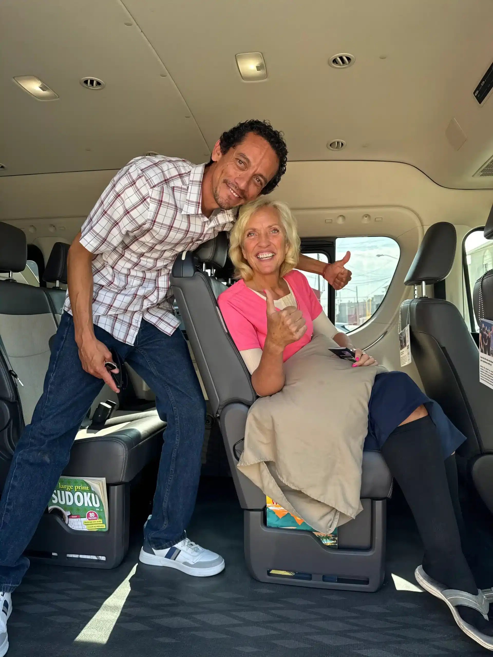 About Us 14 Happy patient giving thumbs up inside a private medical transport van, on her way to see vetted doctors and board-certified surgeons in Tijuana.