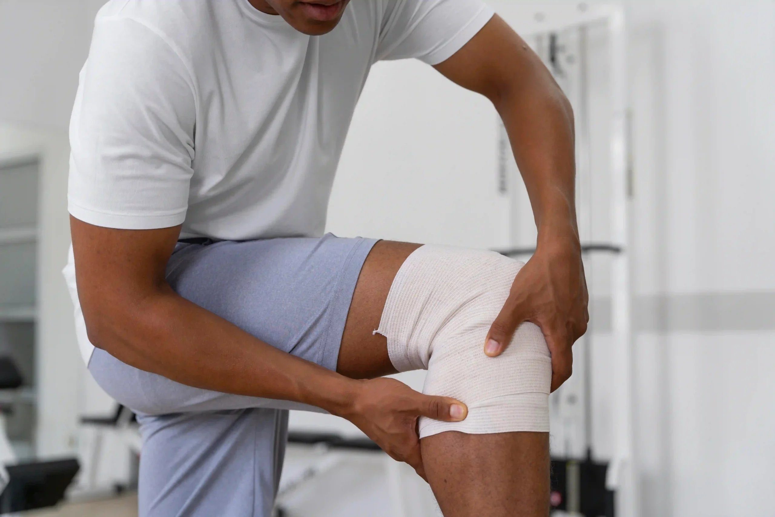 ACL Reconstruction in Tijuana, Mexico 11 Patient with a bandaged knee considering ACL Reconstruction in Tijuana after a sports injury.