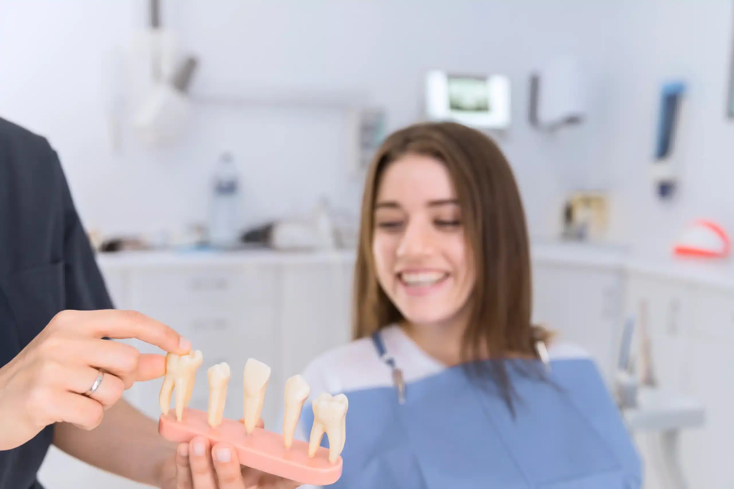 Tooth Implants in Tijuana, Mexico 12 Patient looking at different types of dental implant models during a consultation in Tijuana, Mexico.
