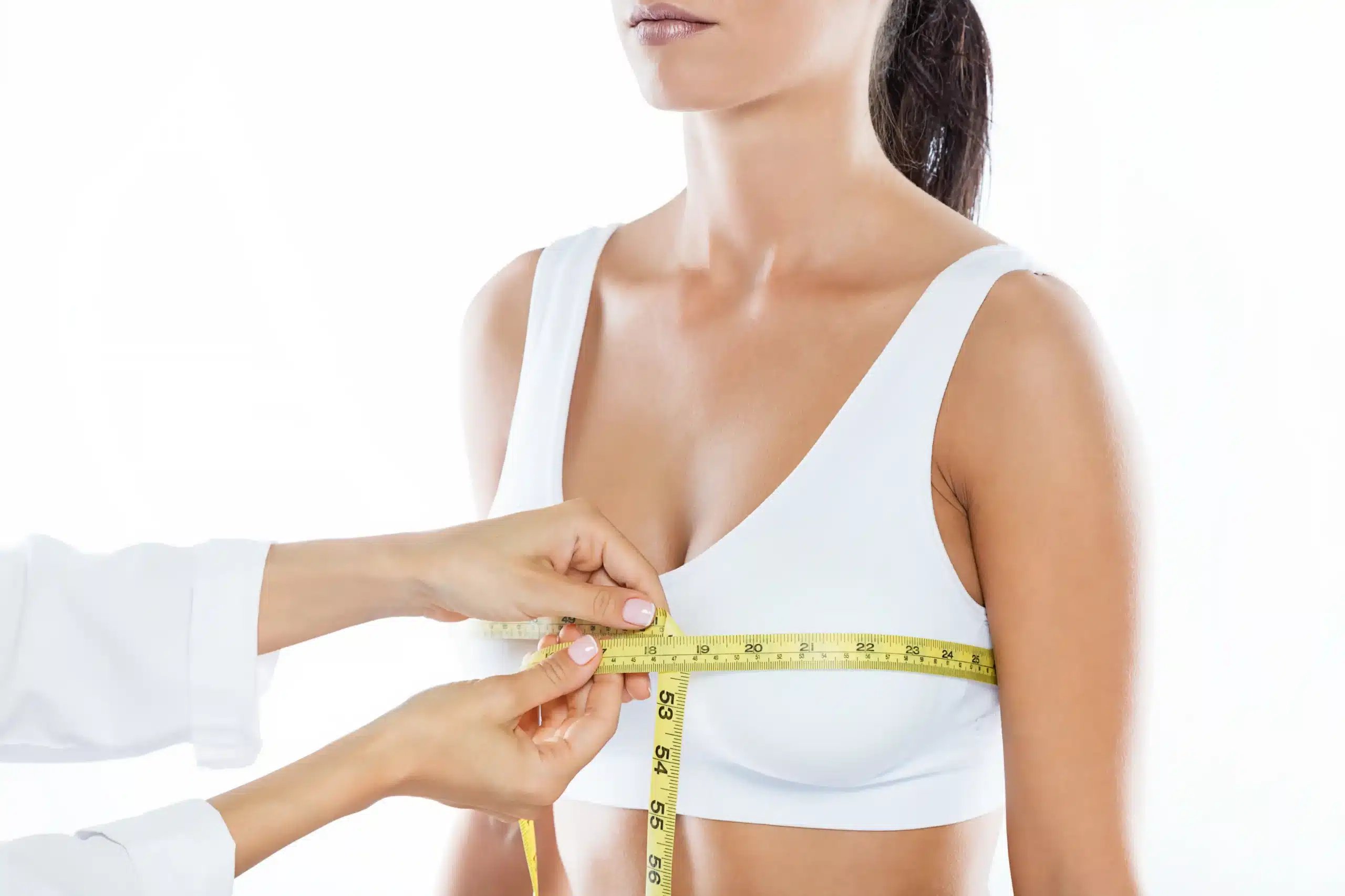 Breast Lift in Tijuana, Mexico 15 Plastic surgeon measuring a patient during a consultation for a breast lift in Tijuana.