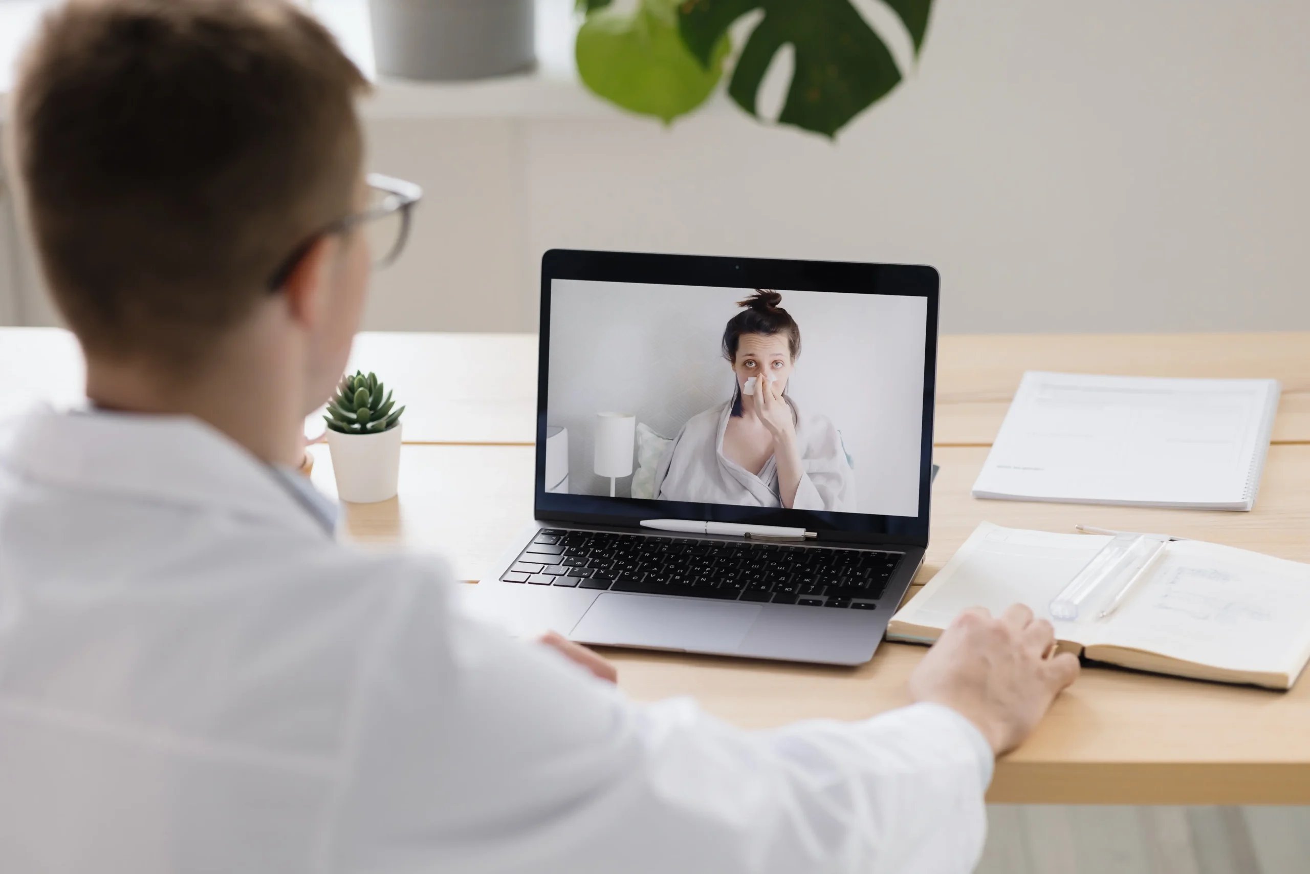 Patient Process 12 A doctor using telemedicine to discuss the patient process for surgery in Mexico with a woman at home.