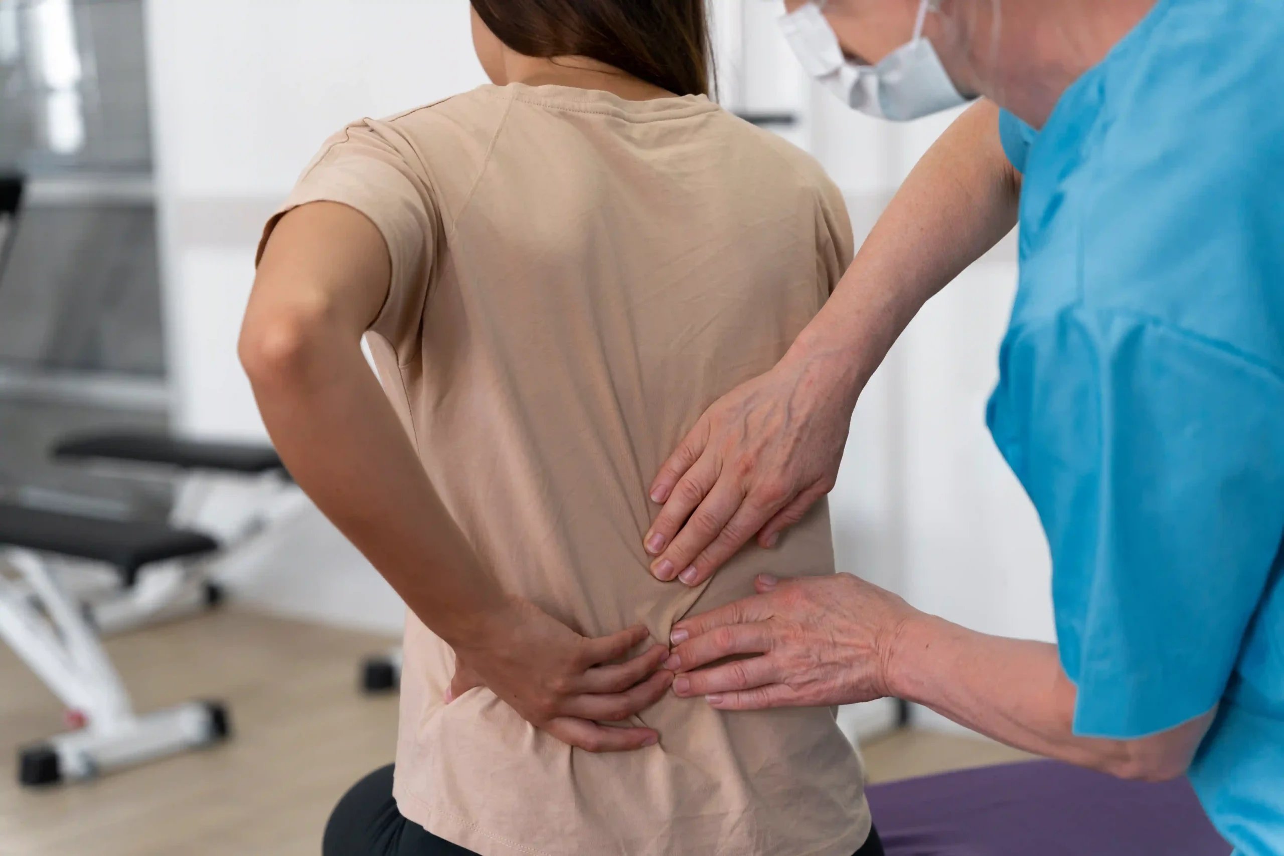Spinal Fusion in Tijuana, Mexico 12 Medical assistant helping a patient with personalized physiotherapy exercises for recovering from spinal fusion surgery in Tijuana.