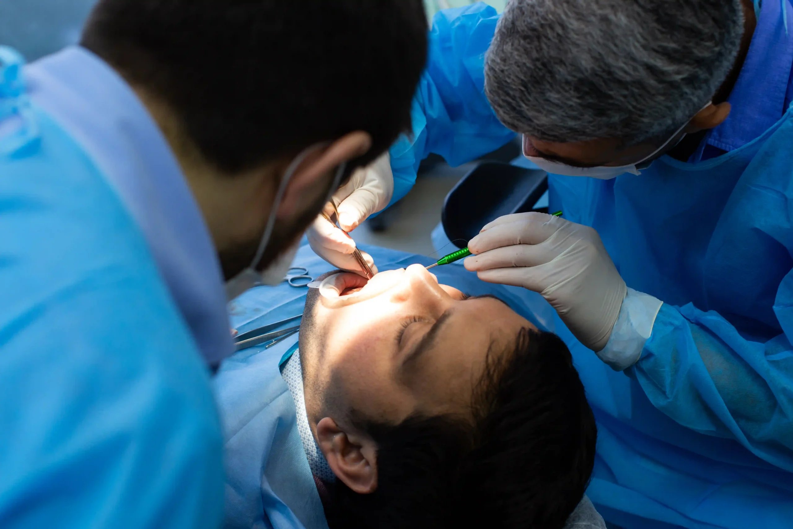 Mouth Reconstruction in Tijuana, Mexico 11 Professional dental team performing surgery for dental implants in Mexico as part of a full mouth restoration.