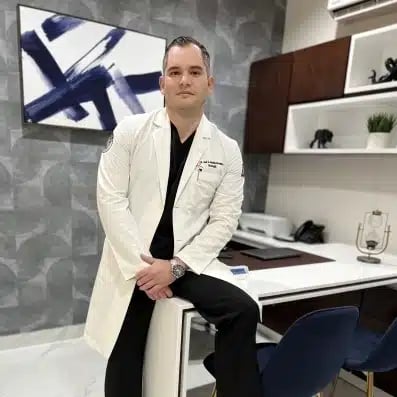 Vetted Doctors in Tijuana | Health & Wellness Bazaar 16 Dr. Gildardo Gaxiola, a board-certified urologist and general surgeon in Tijuana, Mexico, posing in his modern medical office at Health and Wellness Bazaar.