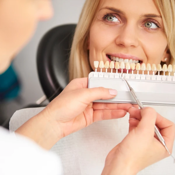 Dentistry in Tijuana, Mexico – A patient undergoing a dental veneer color matching procedure for a bright, confident smile.