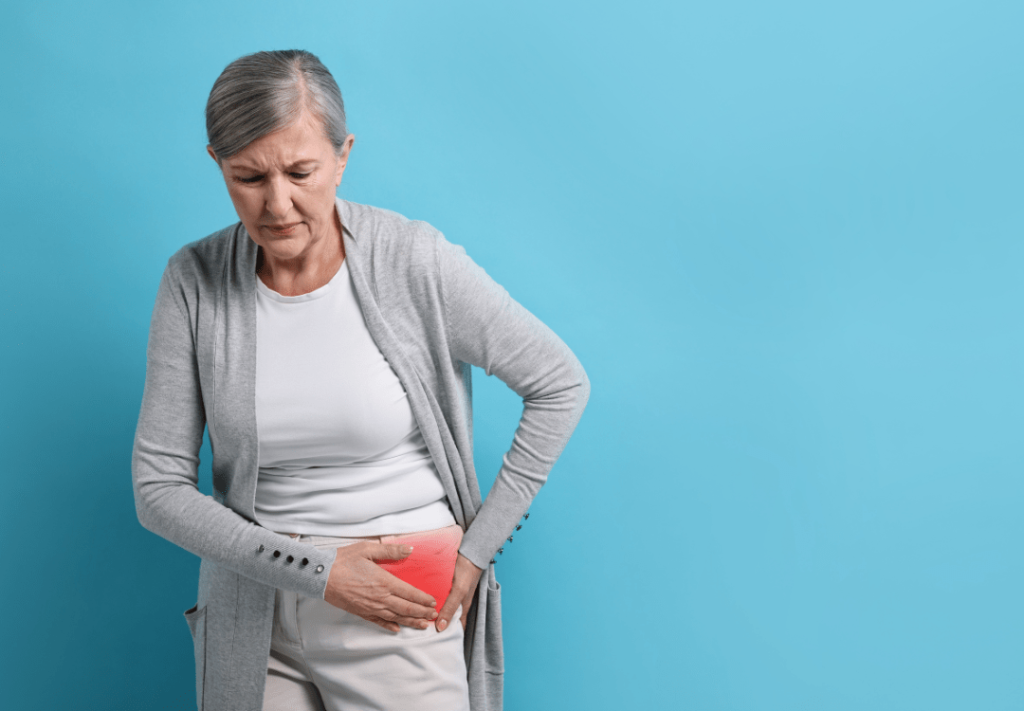 An elderly woman clutching her hip in pain, representing chronic hip issues and the need for hip replacement surgery for improved mobility and relief.