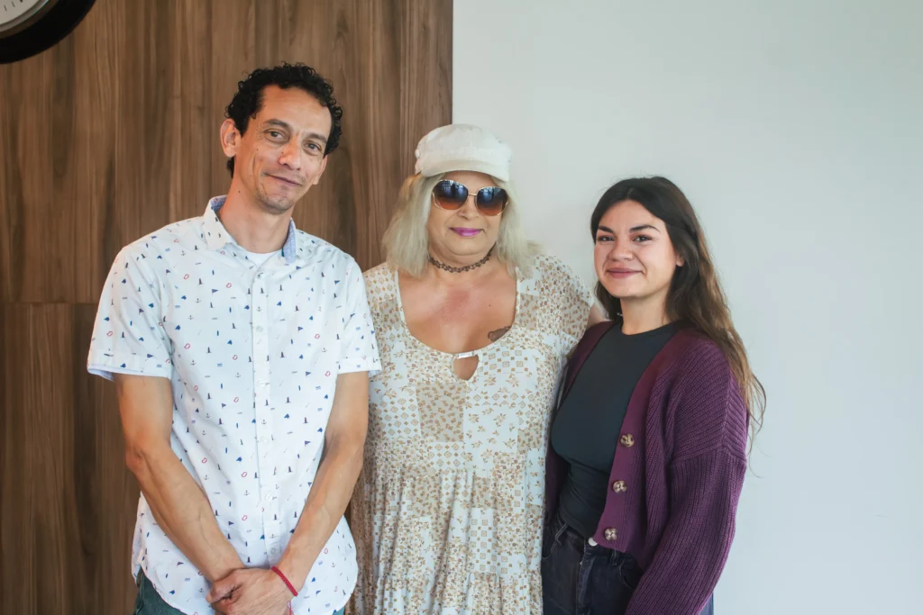 Medical Tourism in Tijuana | Affordable Surgery Packages 23 Three individuals (a man, a person wearing a hat and sunglasses, and a young woman) posing together in a clinic setting. The image promotes diversity and inclusive patient support.
