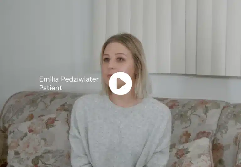 Emilia Pedziwiater, patient, sitting on a couch, giving her testimonial about her medical experience.