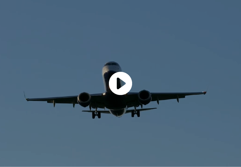 Medical Tourism in Mexico 21 A passenger airplane approaching for landing against a blue sky, symbolizing travel and medical tourism packages.