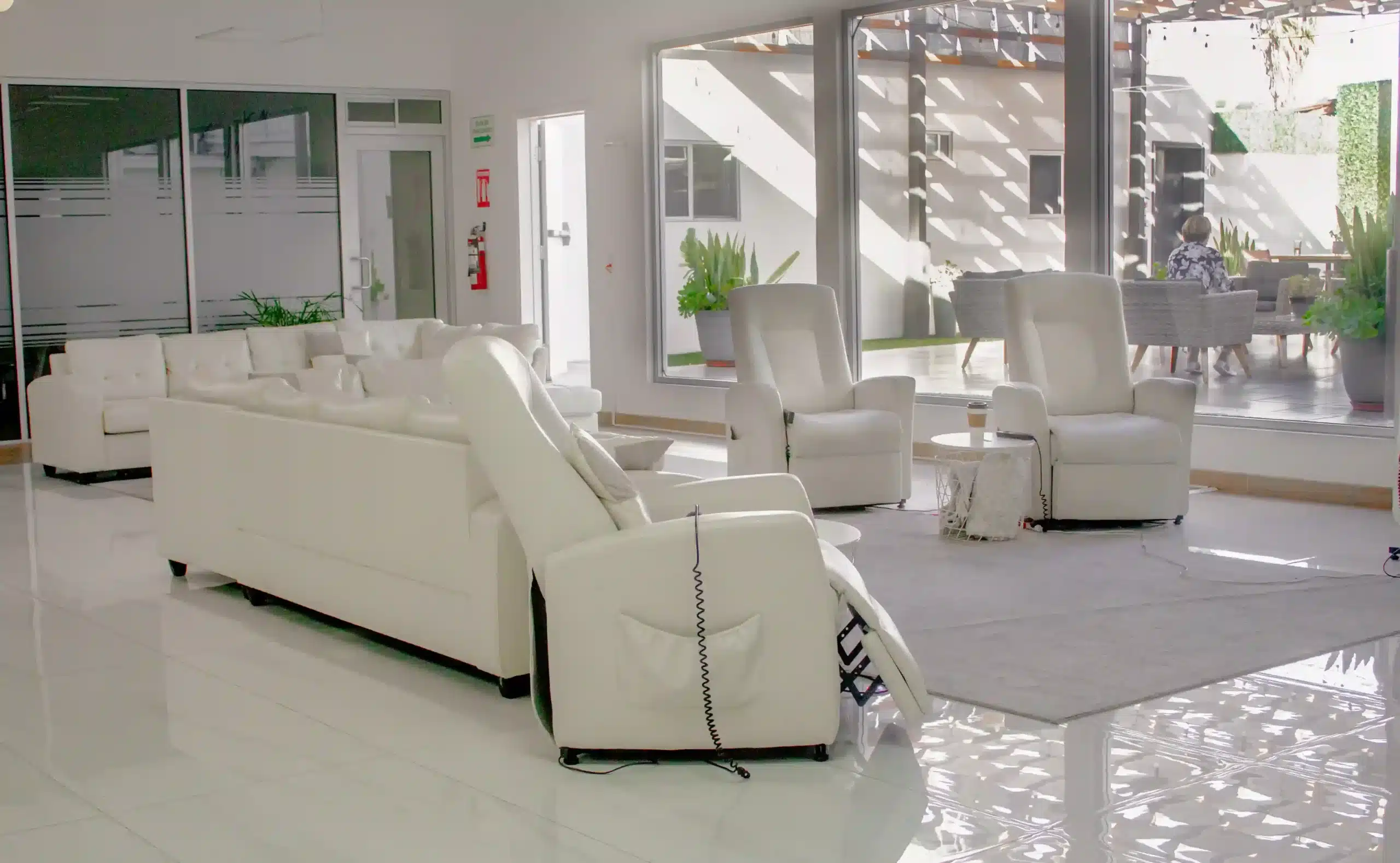 Transgender Surgery in Tijuana, Mexico 13 Modern and bright recovery lounge in Tijuana with comfortable recliner chairs, offering a safe space and relaxing environment for gender affirmation surgery patients.
