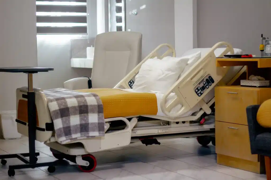 Gastric Sleeve Surgery in Tijuana, Mexico 14 Modern, comfortable hospital bed and high-end furniture in a private room in Tijuana, focused on post-operative recovery for transgender surgery patients.