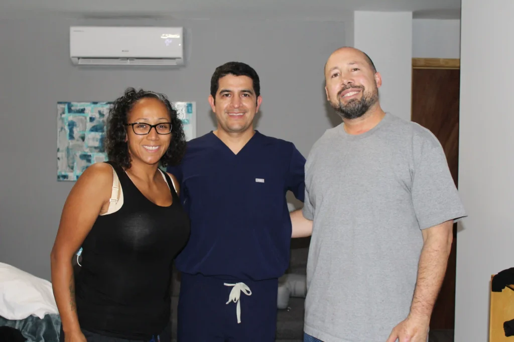 Plastic Surgery in Tijuana, Mexico 13 Smiling couple standing with their board-certified plastic surgeon in Mexico after a successful procedure, showcasing the trust in plastic surgery in Tijuana.