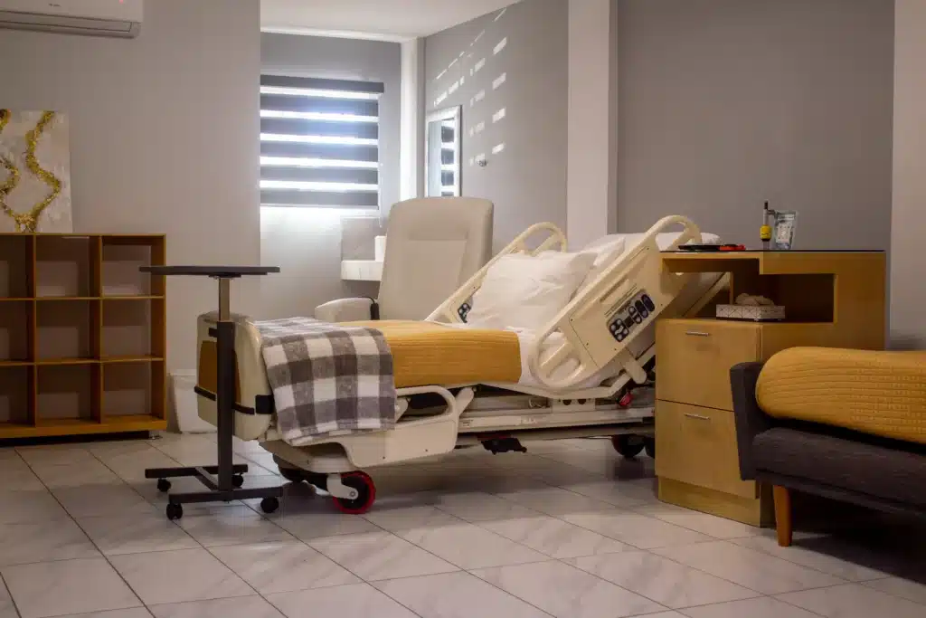 Breast Augmentation In Tijuana, Mexico 23 Modern private hospital room in Tijuana featuring an advanced adjustable hospital bed and comfortable guest recliner for post-surgery recovery.