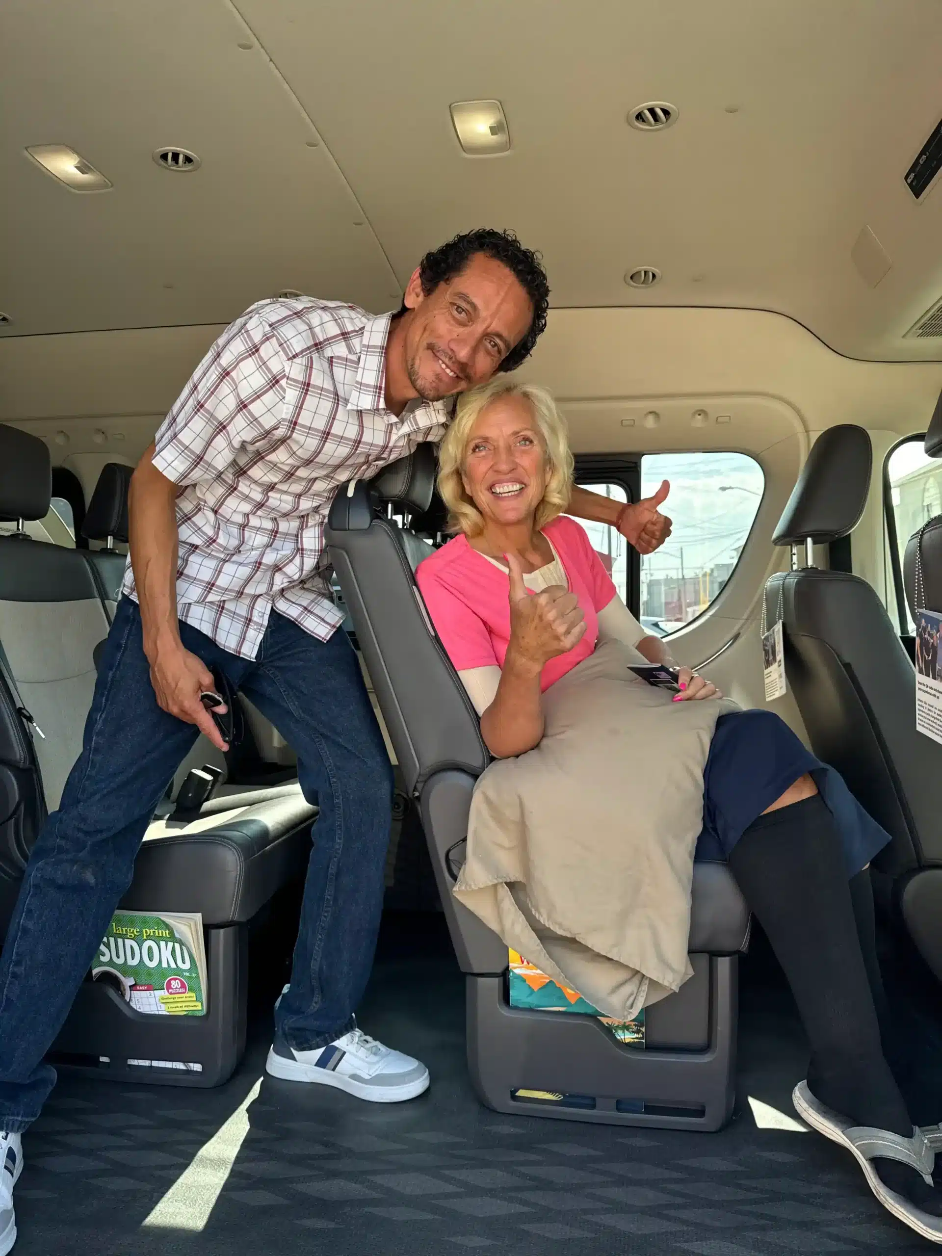 About Us 16 Happy patient giving thumbs up inside a private medical transport van, on her way to see vetted doctors and board-certified surgeons in Tijuana.