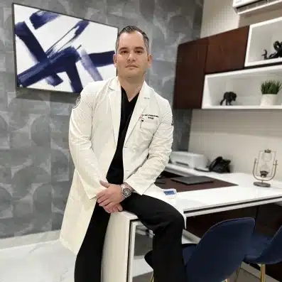 Vetted Doctors in Tijuana | Health & Wellness Bazaar 16 Dr. Gildardo Gaxiola, a board-certified urologist and general surgeon in Tijuana, Mexico, posing in his modern medical office at Health and Wellness Bazaar.