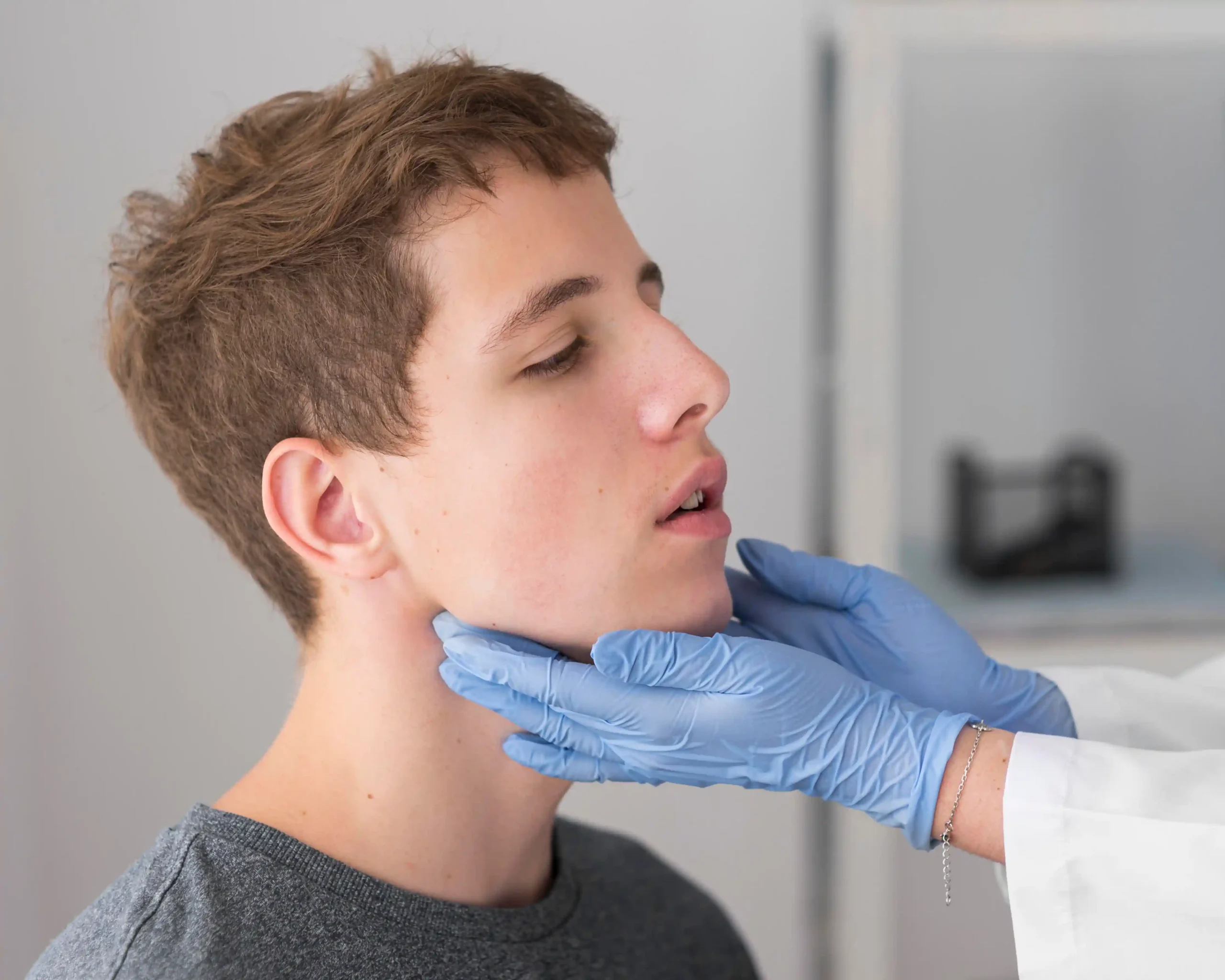Mouth Reconstruction in Tijuana, Mexico 12 A doctor performing a clinical neck and jaw evaluation for a patient seeking mouth reconstruction in Tijuana.