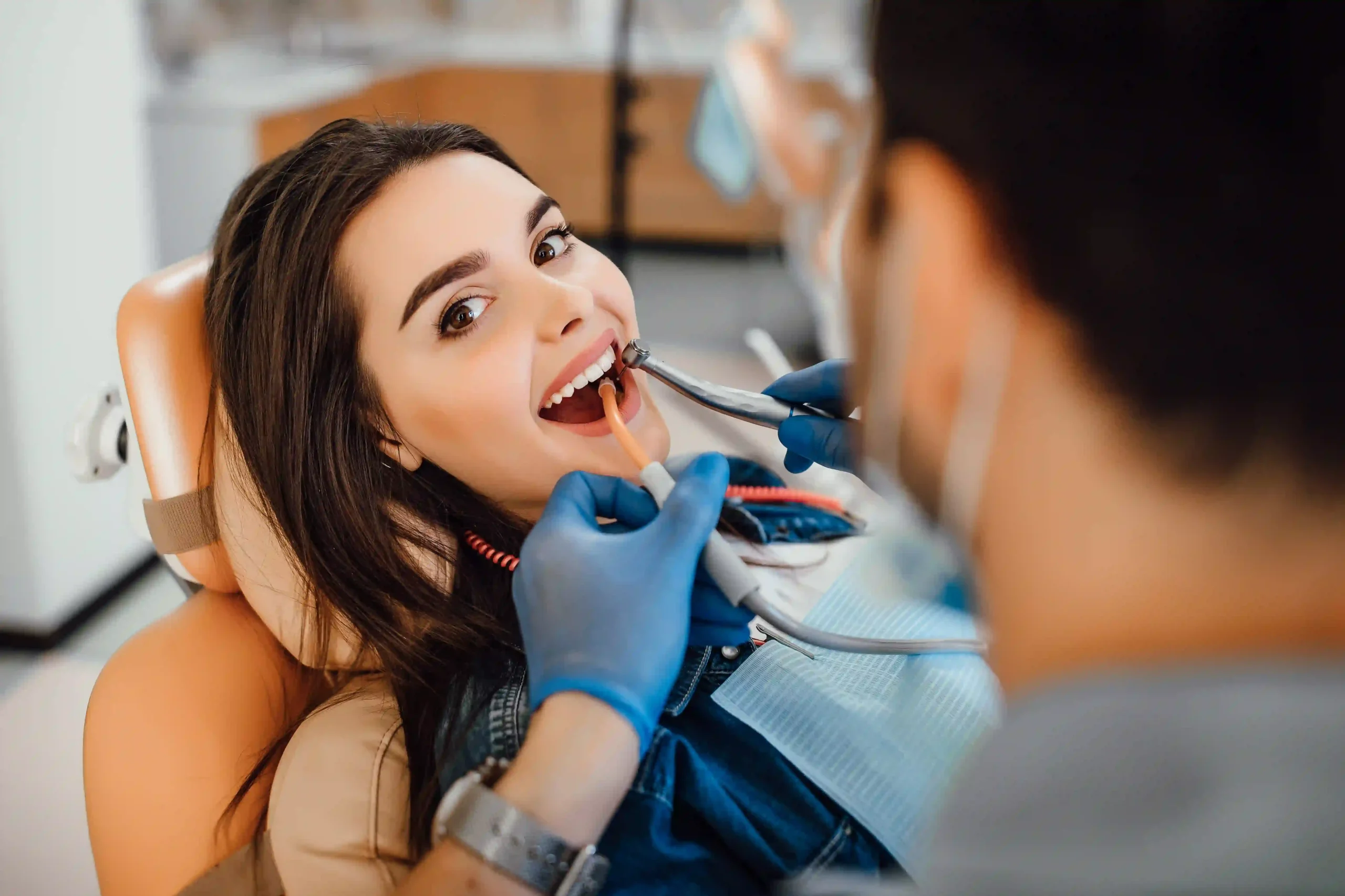 Dental Care in Tijuana, Mexico 12 A happy young woman receiving professional dental care in Tijuana, illustrating the high standard of preventive dentistry in Mexico.
